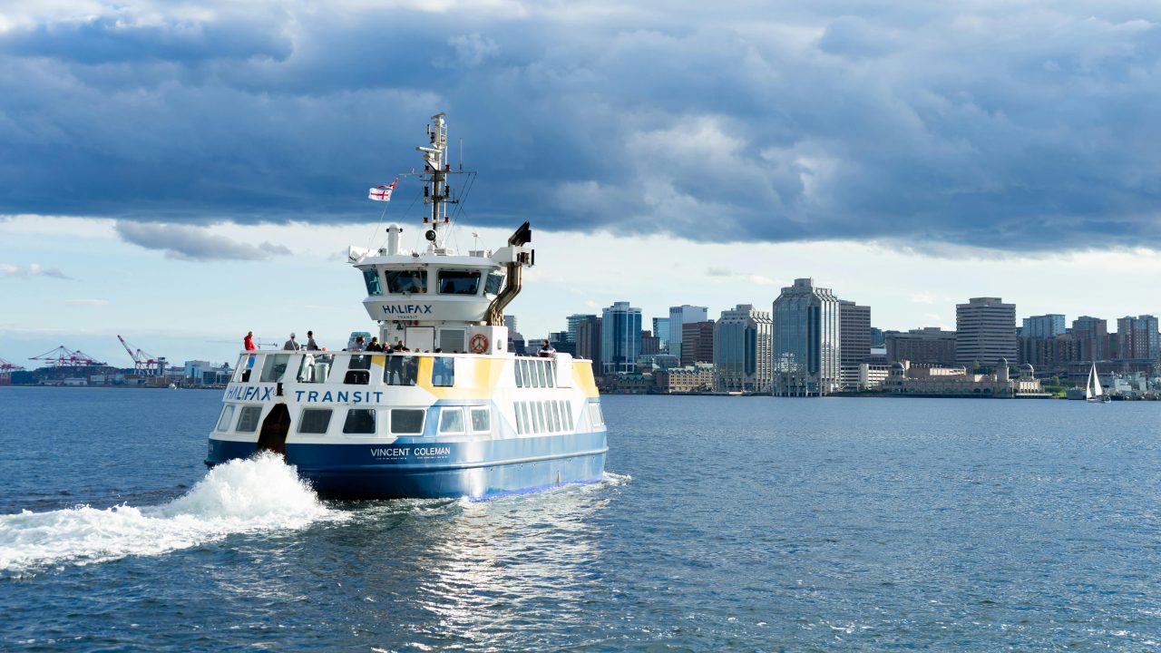 A Halifax Transit ferry sails to Halifax on a sunny, calm day. 