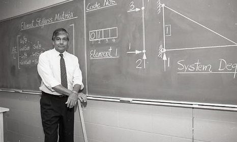 Civil Engineering Professor Dr. Mel Hosain standing at a blackboard.