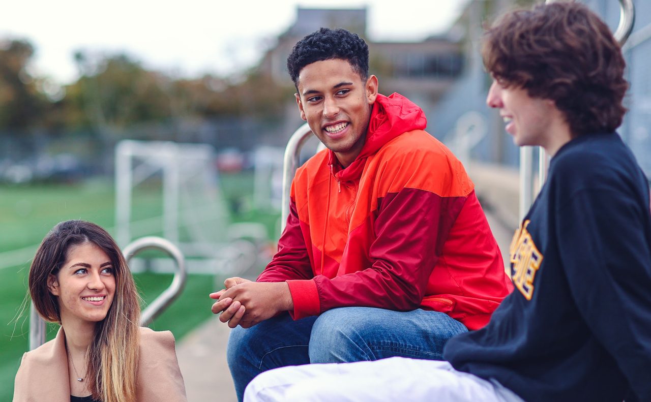 Students chatting on the seats of the Wickwire field Recruitment Campaign 2021