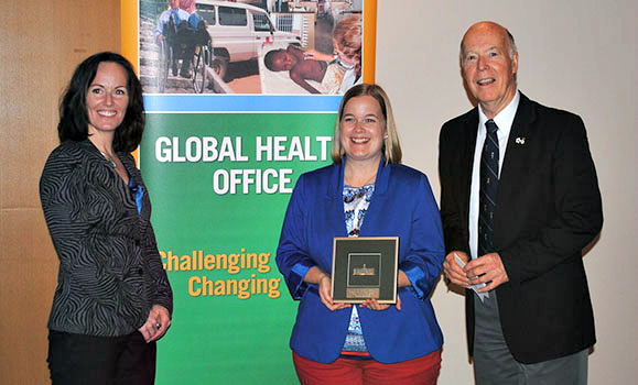 Danielle (centre) receives her award from Shawna O'Hearn (Director of the Global Health Office) and Dr. Ron Stewart.