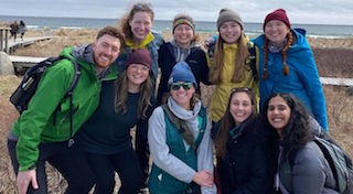 A group of students on a research visit to a beach