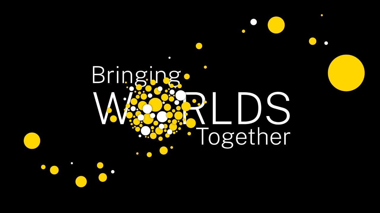 A black background with yellow circles and the words Bringing Worlds Together in white