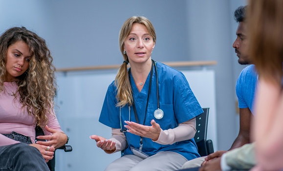 Nurse speaking to a group of patients