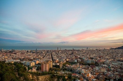 A panoramic view of the city of Barcelona, Spain at sunset. 
