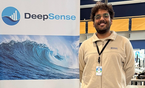 Shail Rajeshbhai Kardani is standing in front of a DeepSense pull-up banner.