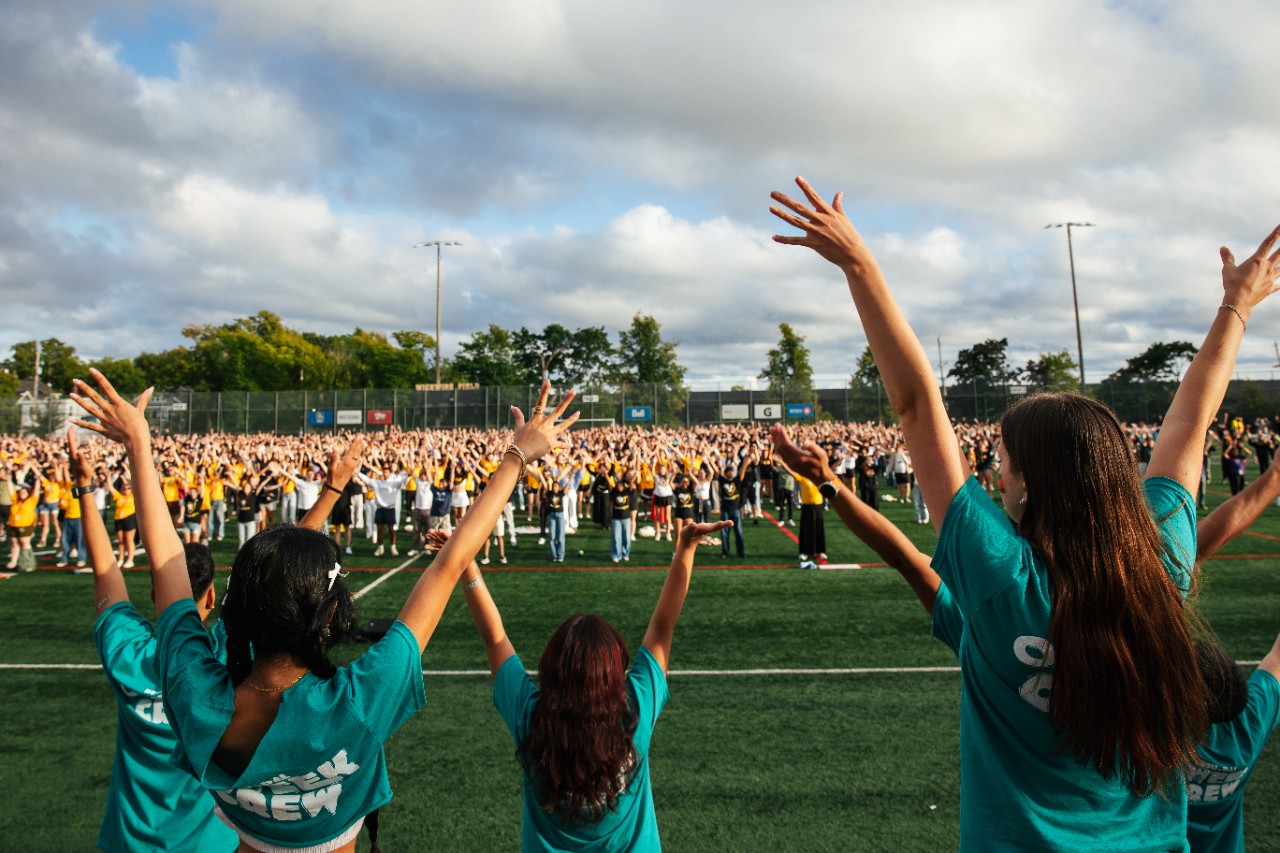 students cheering for those on the field