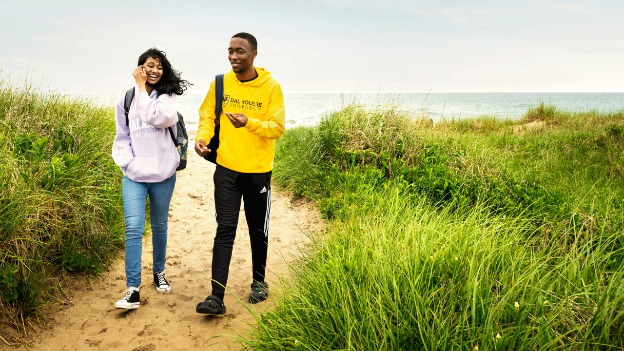 two students walking on east coast beach