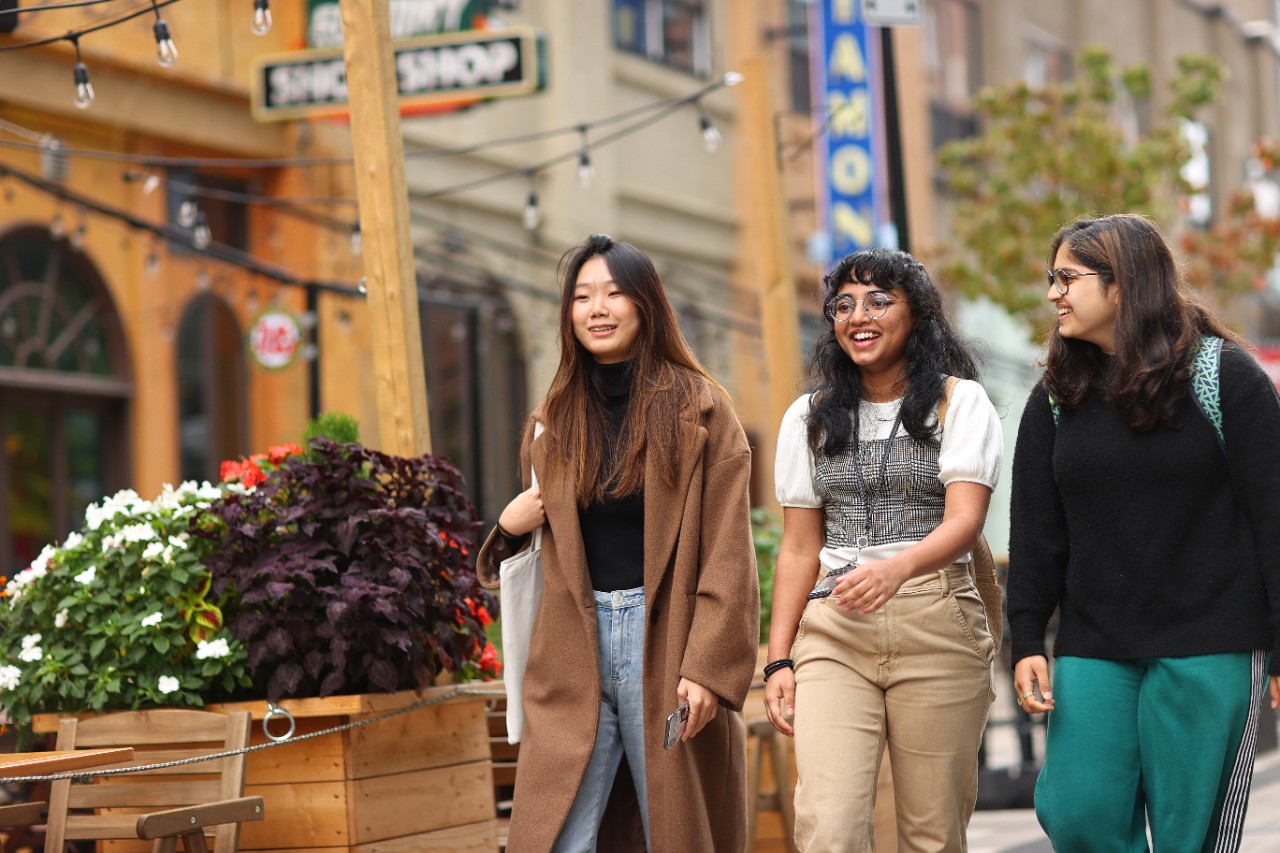 three students walking on a street in downtown Halifax