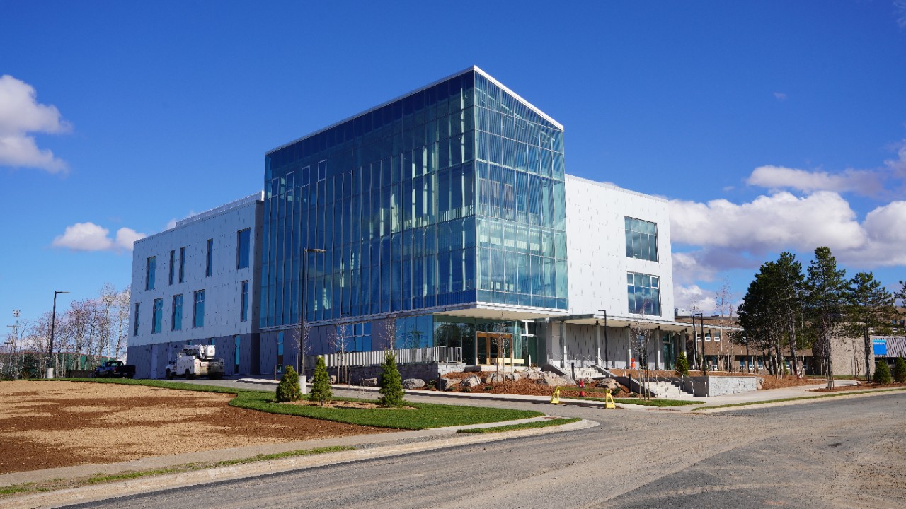 The medical sciences building is a large white and glass building.