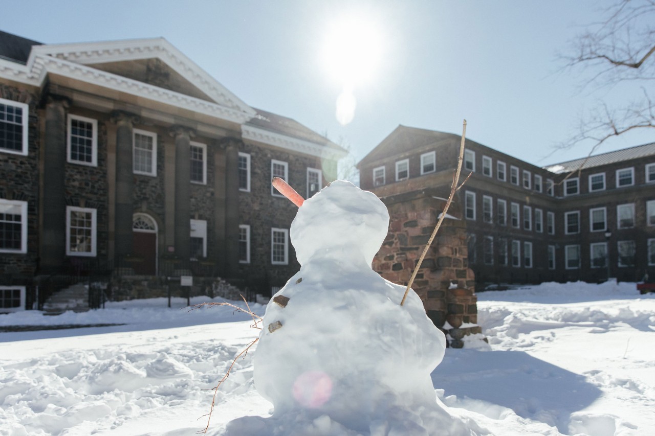 Snowman stands on Studley Quad in front of the University Club.