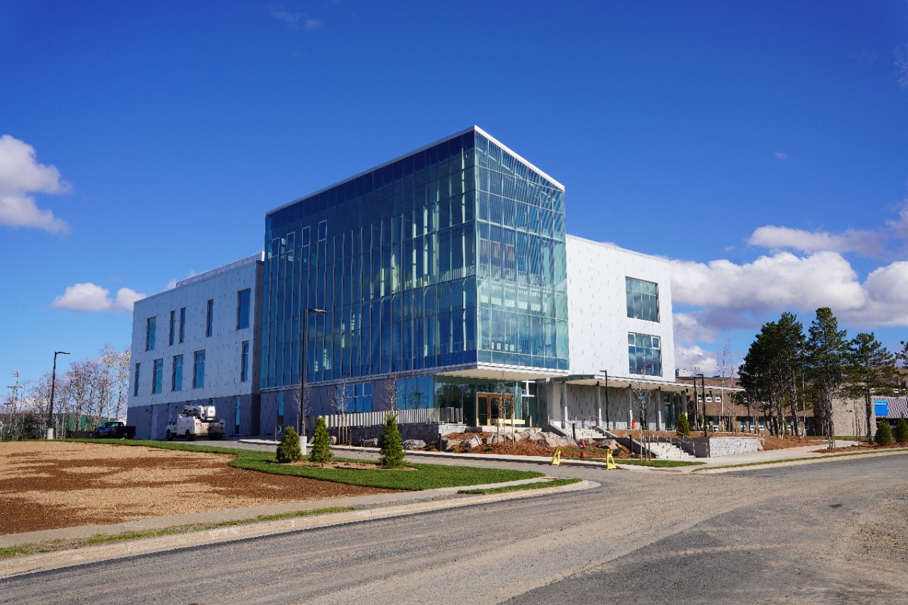 The medical sciences building is a large white and glass building.