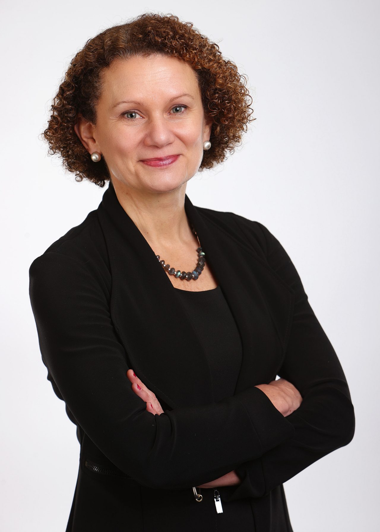 Sheila Blair-Reid stands with arms crossed.