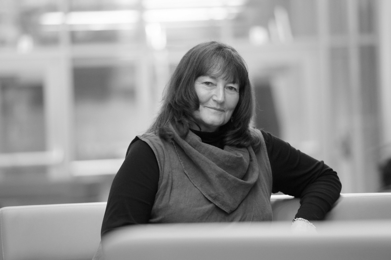 Black and white photo of Dr. Anne Marie Ryan seated on a sofa.