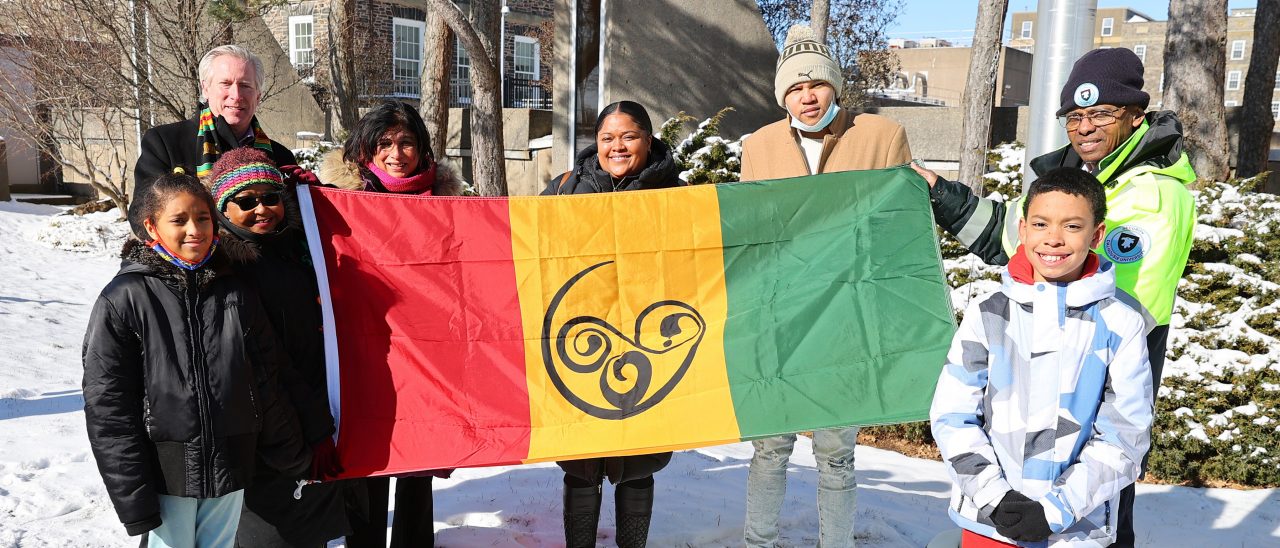 Dal staff, community members and children pose with the African Nova Scotian flag on campus.