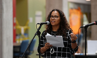 Melisa Marsman speaking at a microphone