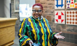  Dr. Barb-Hamilton Hinch speaking at a microphone 