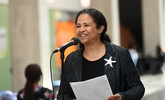 Michelle Williams speaking at a microphone