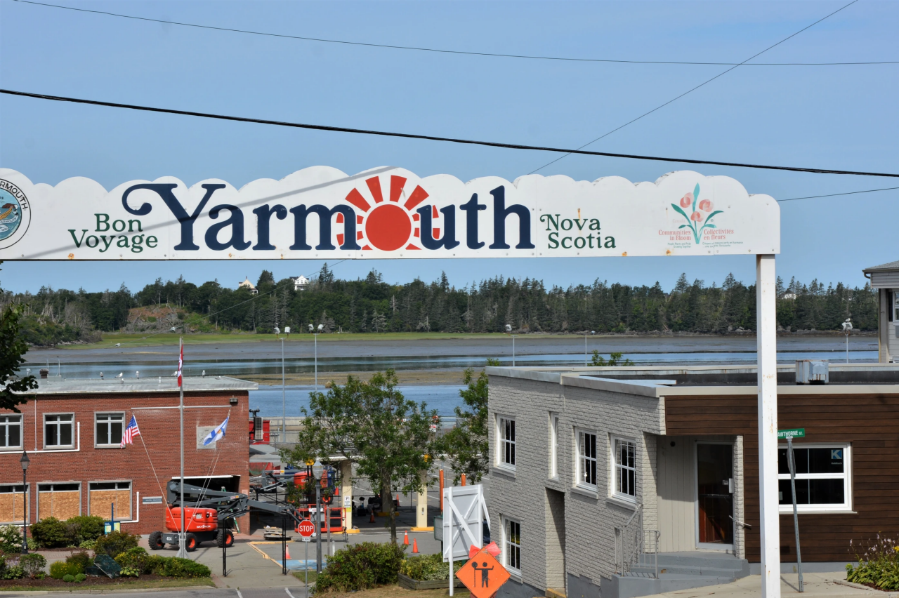 Bon Voyage Yarmouth Nova Scotia sign above a street with water in the background