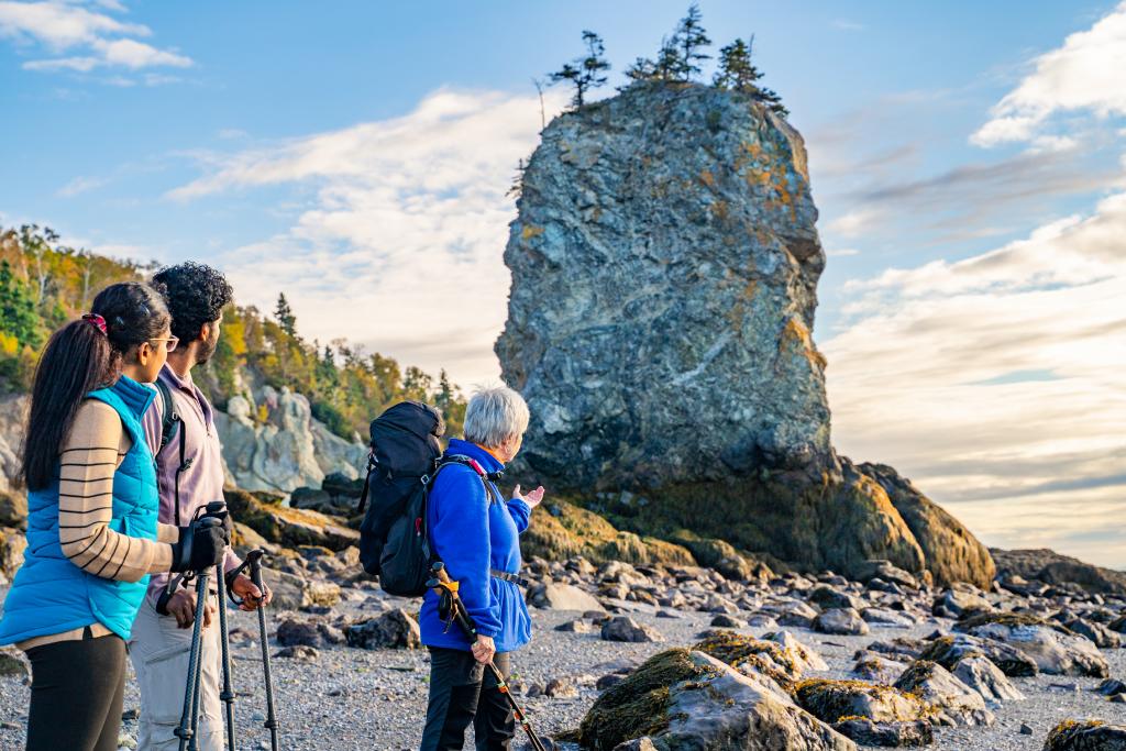 Three people on a rocky beach in Amherst