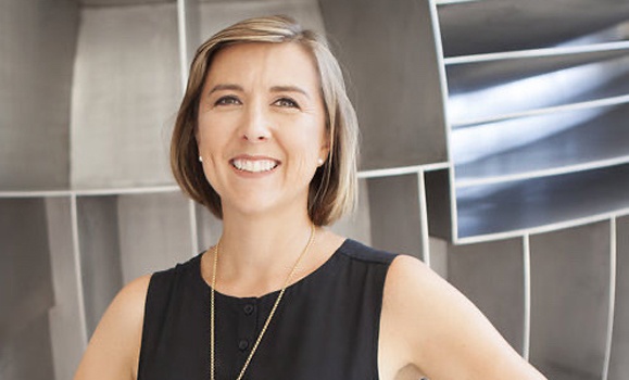 Portrait of a woman with short blonde hair wearing a black shirt.