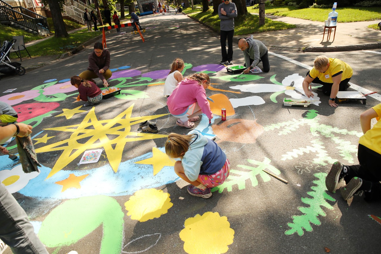 community members painting a street mural