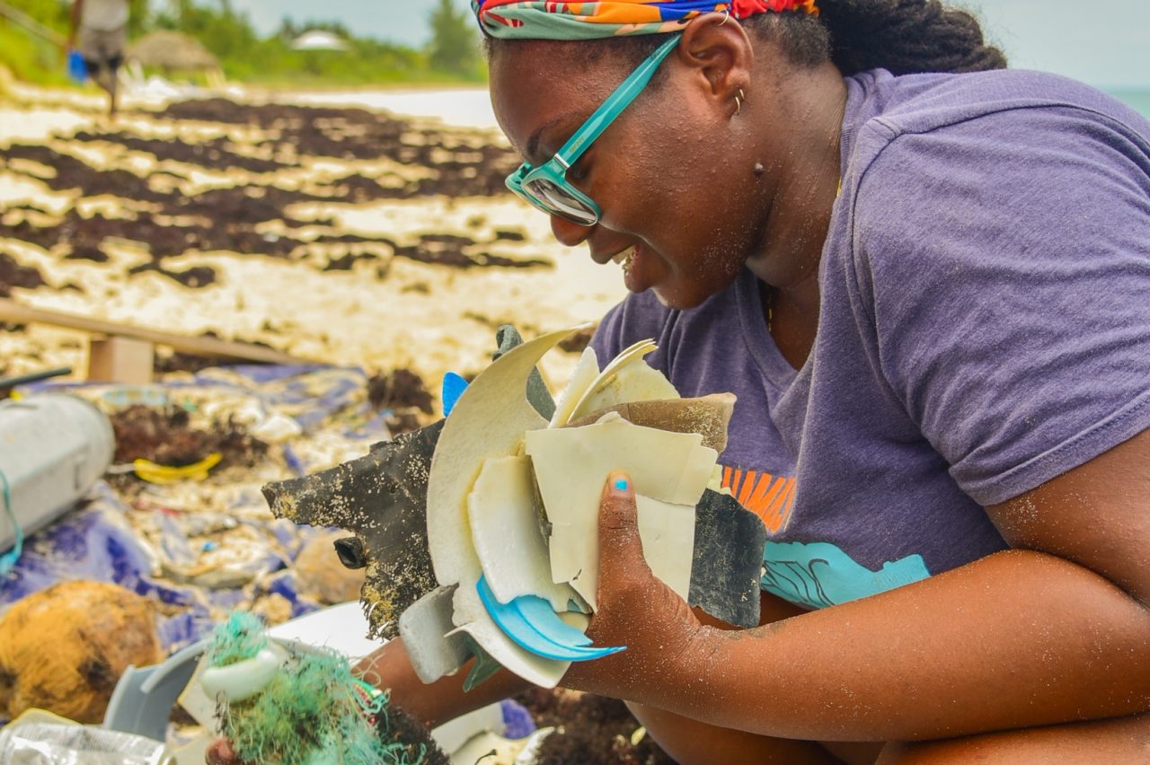 Dr. Kristal Ambrose collects plastic pollution on a beach