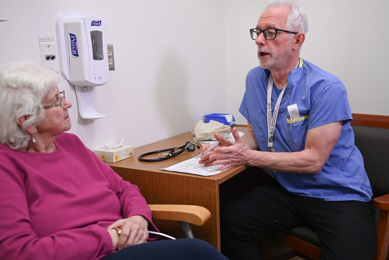 Dr. Kenneth Rockwood speaks to an elderly patient