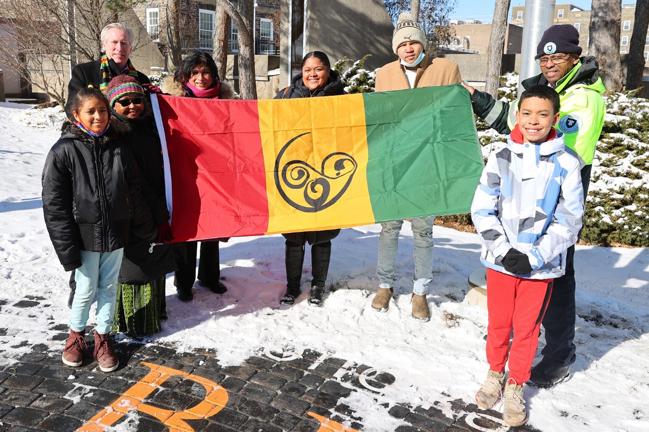 Dal staff, community members and children pose with the African Nova Scotian flag on campus.