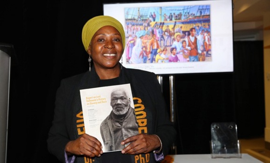 Dr. Afua Cooper holds a printed copy of the final Lord Dalhousie report.