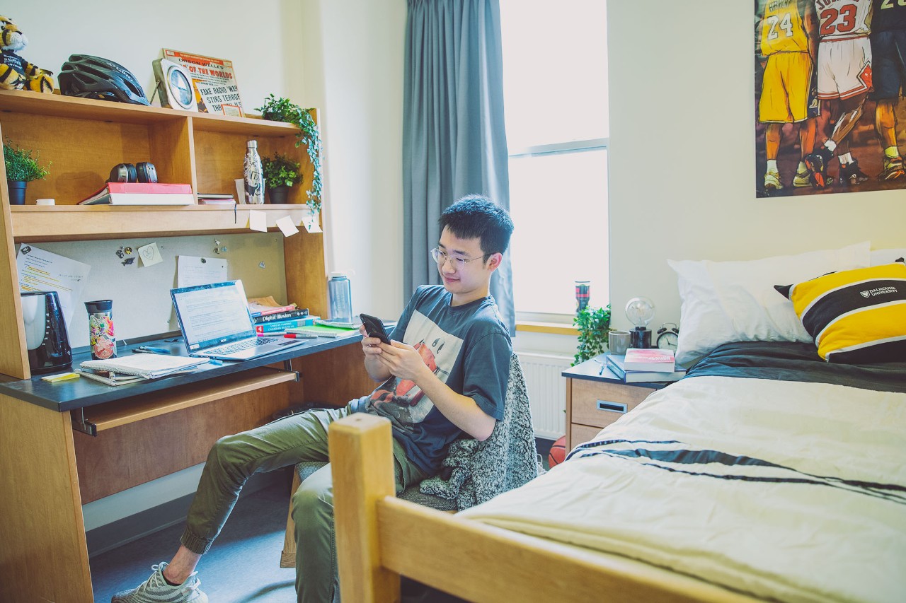 Student sitting at his desk in his residence room Recruitment Campaign 2021