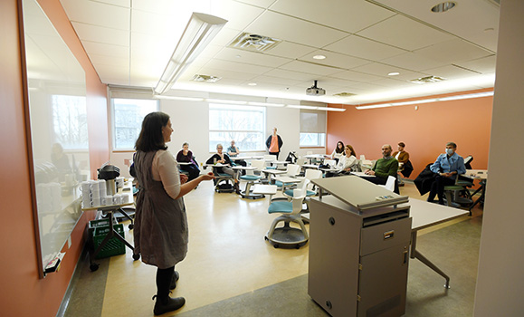 Lisa Binkley teaches in front of an active learning classroom.