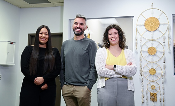 Dr. Shanté Blackmore, Dr. Brent Young and  Jordin Fletcher are standing together in a patient room. 