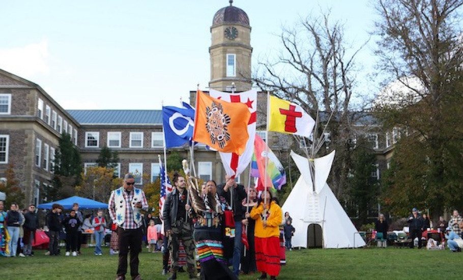 Eileen Brooks leads a flag procession on the Studley quad.