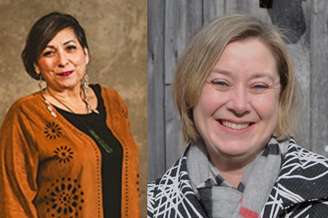 Stacy Allison-Cassin on the left is wearing a grey and white striped blazer and scarf. Camille Callison on the left is wearing an orange sweater, black shirt, and long dangling earrings. Both women are smiling at the camera. 