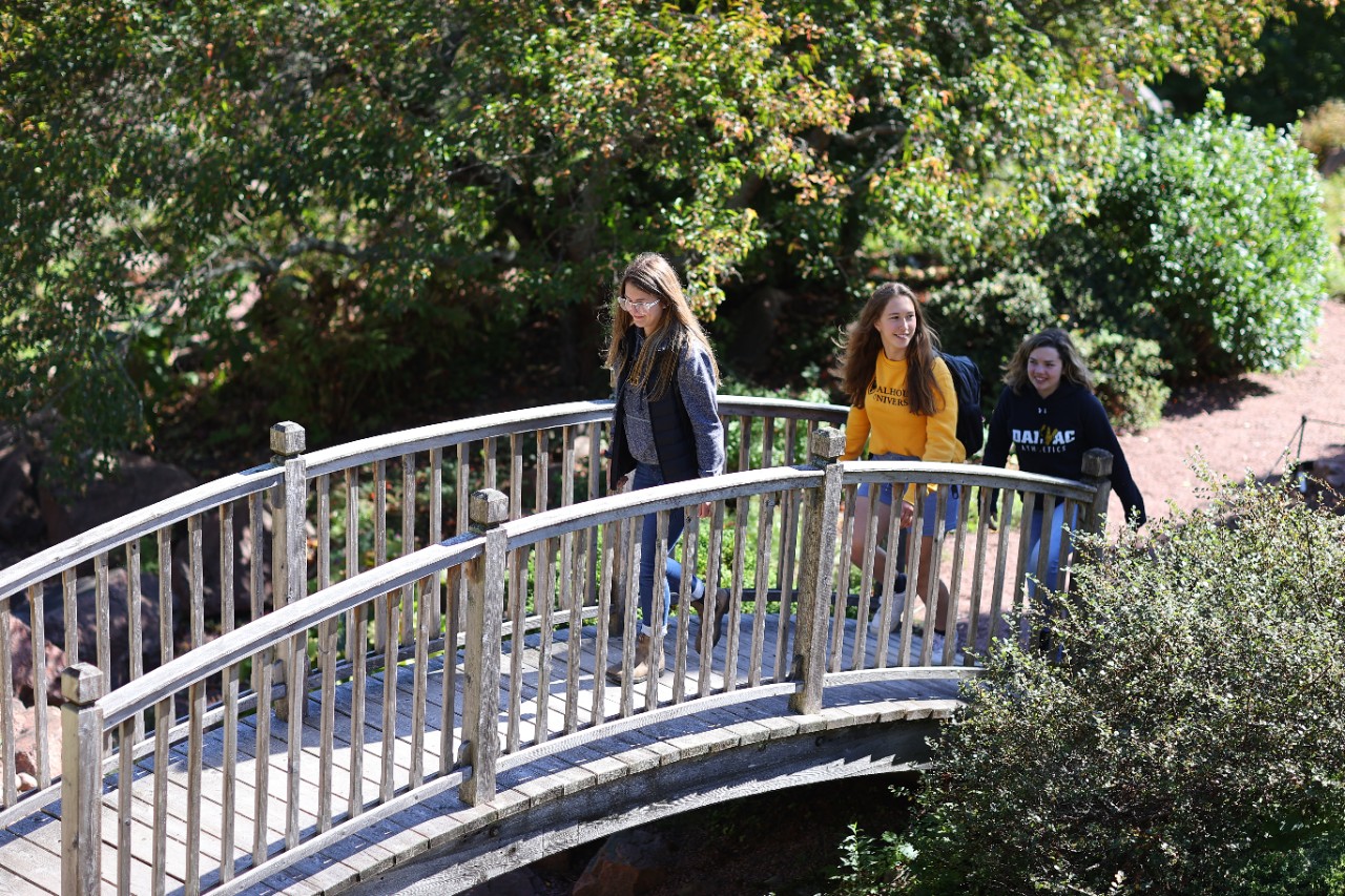 Students walk over a wooden footbridge on Dalhousie's Agriculture campus.