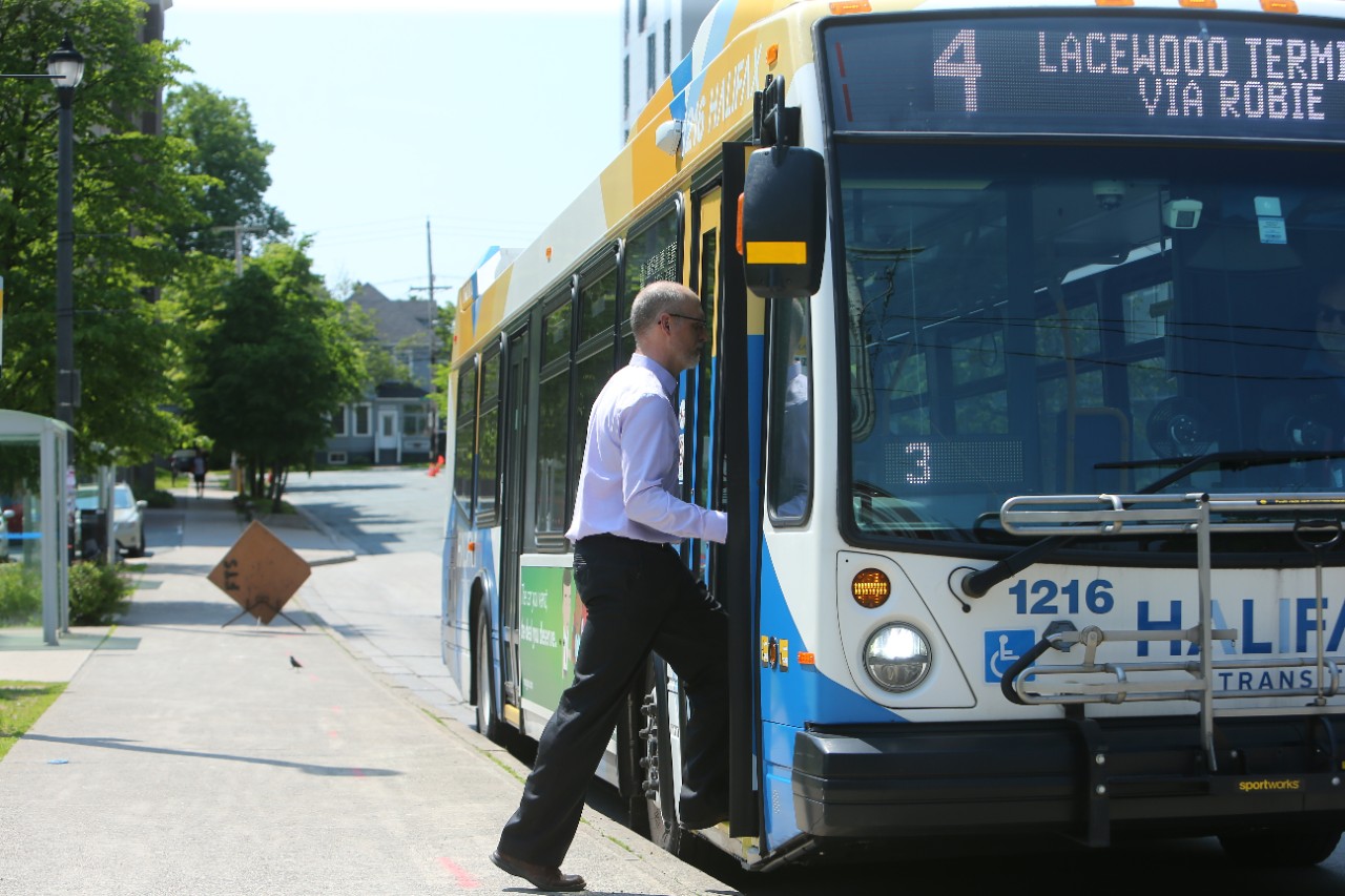 A man boards a Halifax Transit bus. 