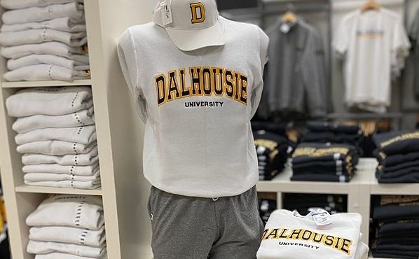 Shelves of Dalhousie merchandise with a mannequin wearing a sweatshirt that says Dalhousie and a baseball cap. 