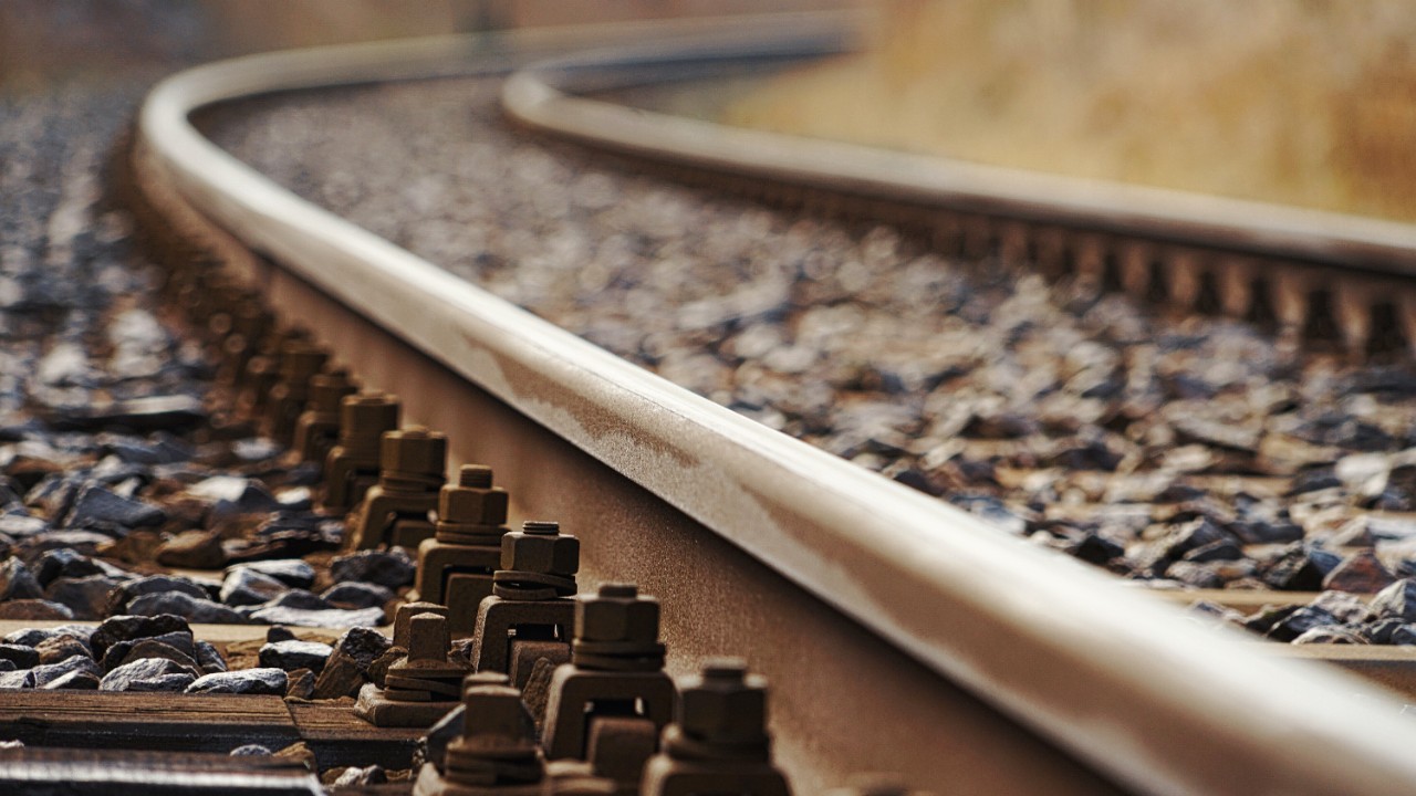 Close-up photo of a railway track curving into the distance.