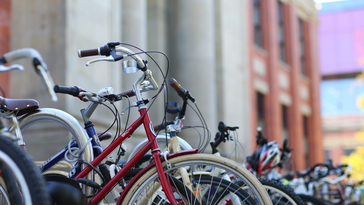 A row of parked bikes outside a brick building on Dal's Sexton Campus.