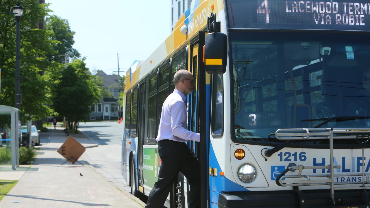 A man boards a Halifax Transit bus. 