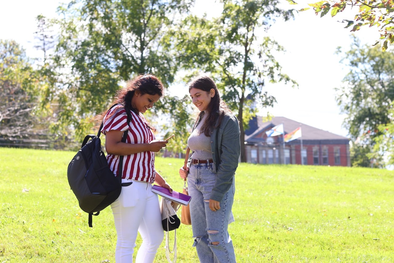 Two students talking outside Cumming Hall