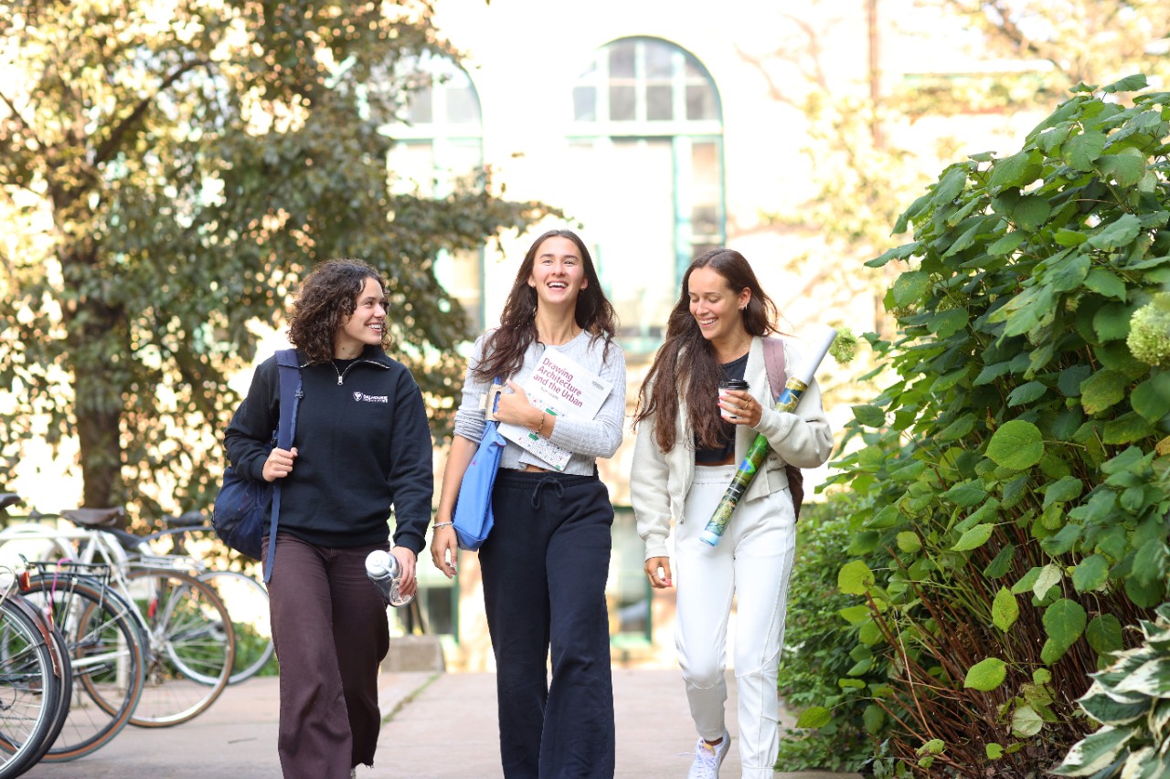 Three students laugh together as they walk on campus at Dalhousie University.