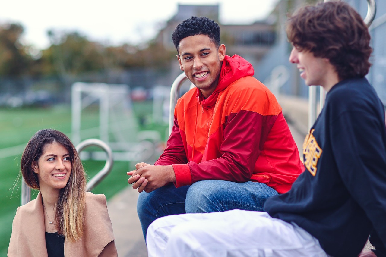 Students chatting on the seats of the Wickwire field Recruitment Campaign 2021