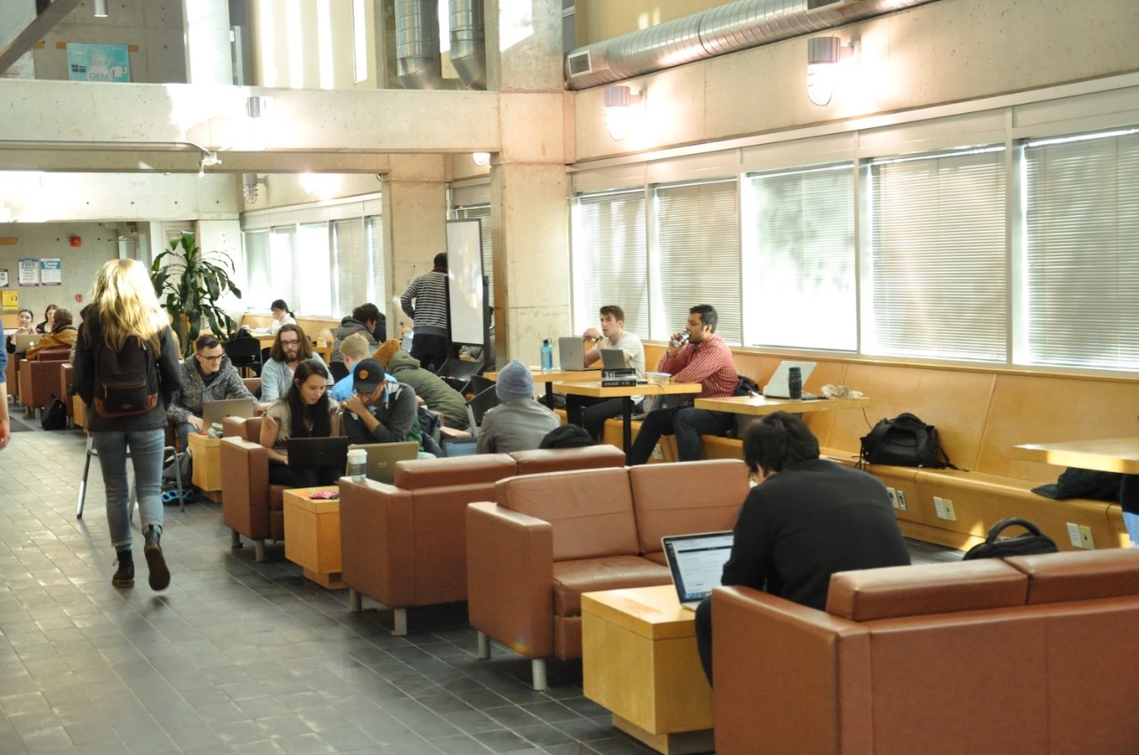 Students study on sofas and chairs in the Computer Science Building cafe.