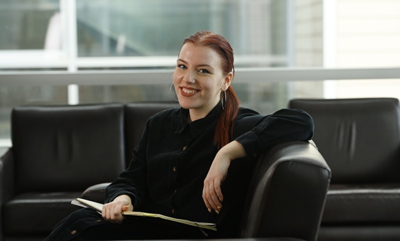Portrait of Anna Gaudet sitting in a chair wearing a black shirt.