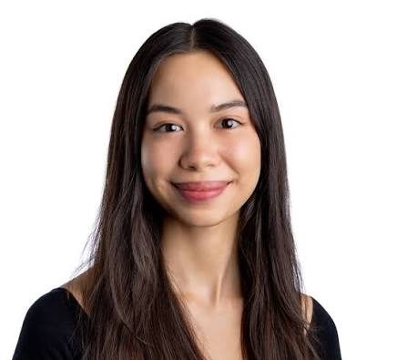 Headshot of student with long dark hair on a white background