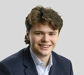 Portrait of Will Jones in a blue sports jacket and light shirt.