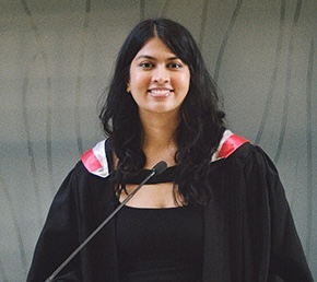 Portrait of Devarshi Shah wearing a black graduation robe.