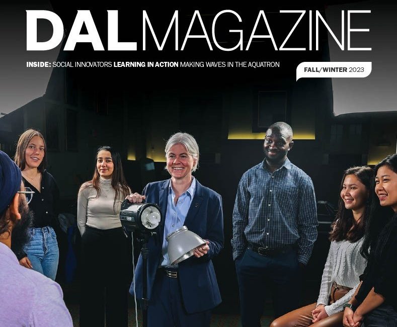 A cover of Dal Magazine with Kim Brooks holding a spotlight surrounded by student.