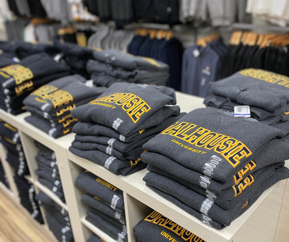 Stack of Dalhousie-branded sweaters for sale.